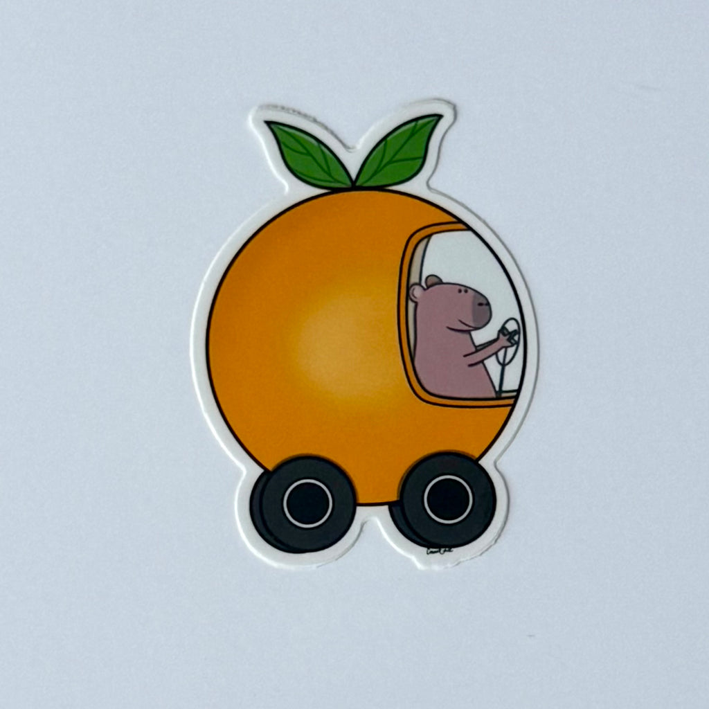 Capybara driving an orange car sticker