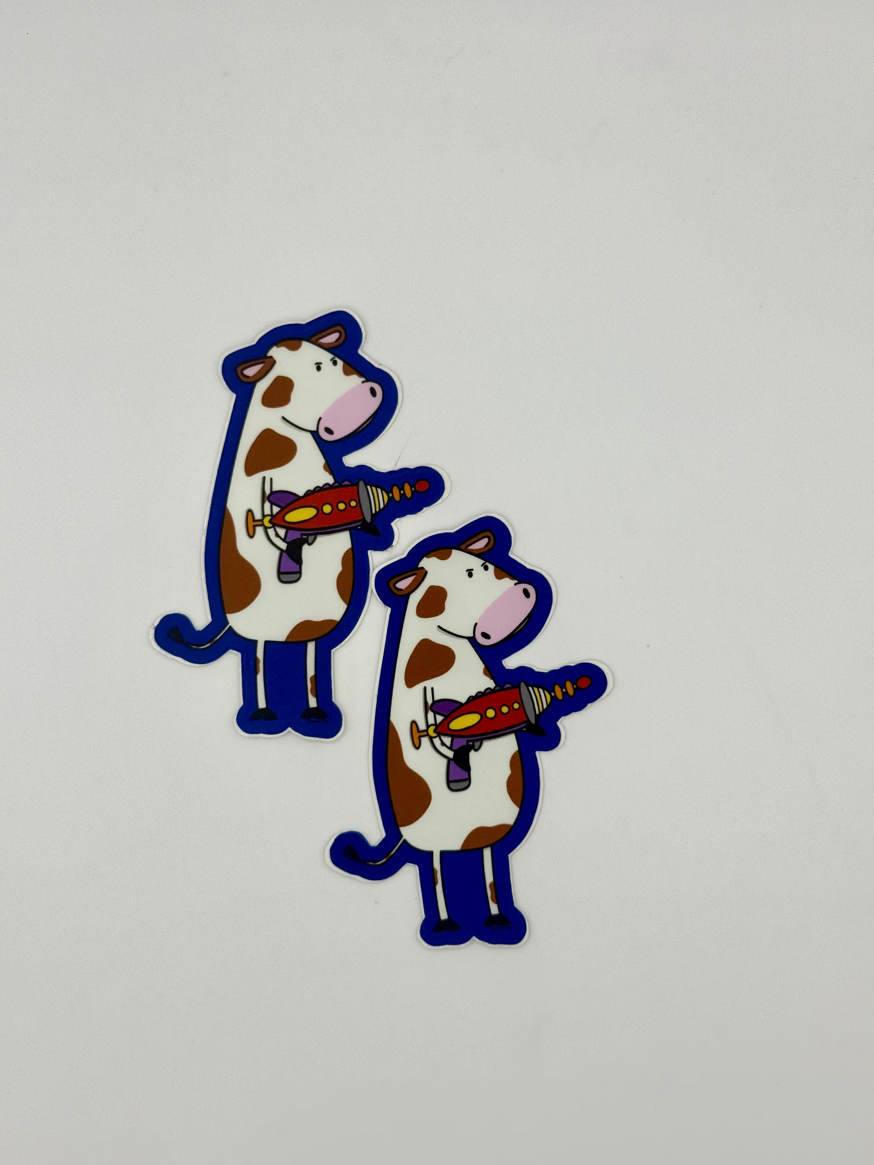 Cow with a ray gun sticker