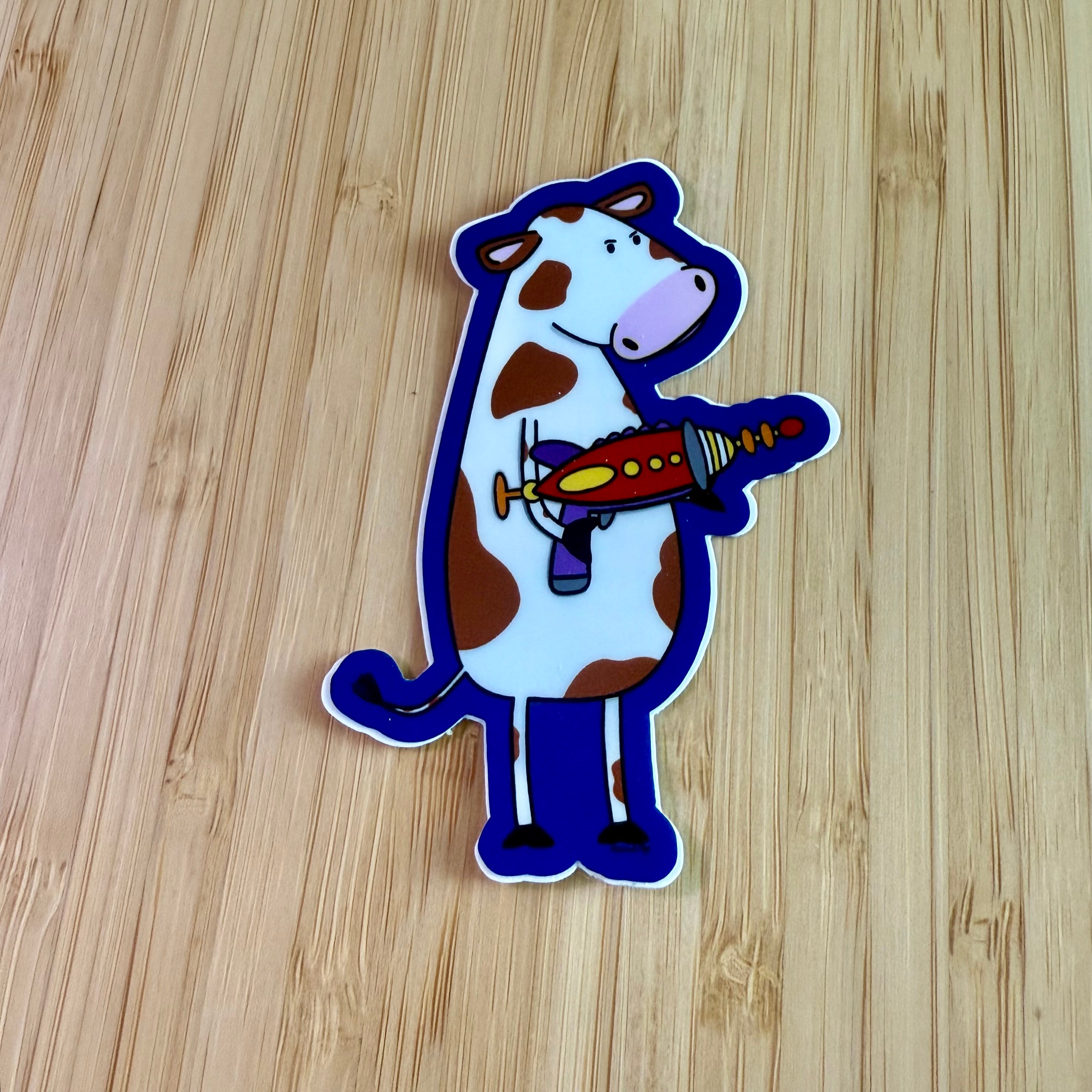 Cow with a ray gun sticker