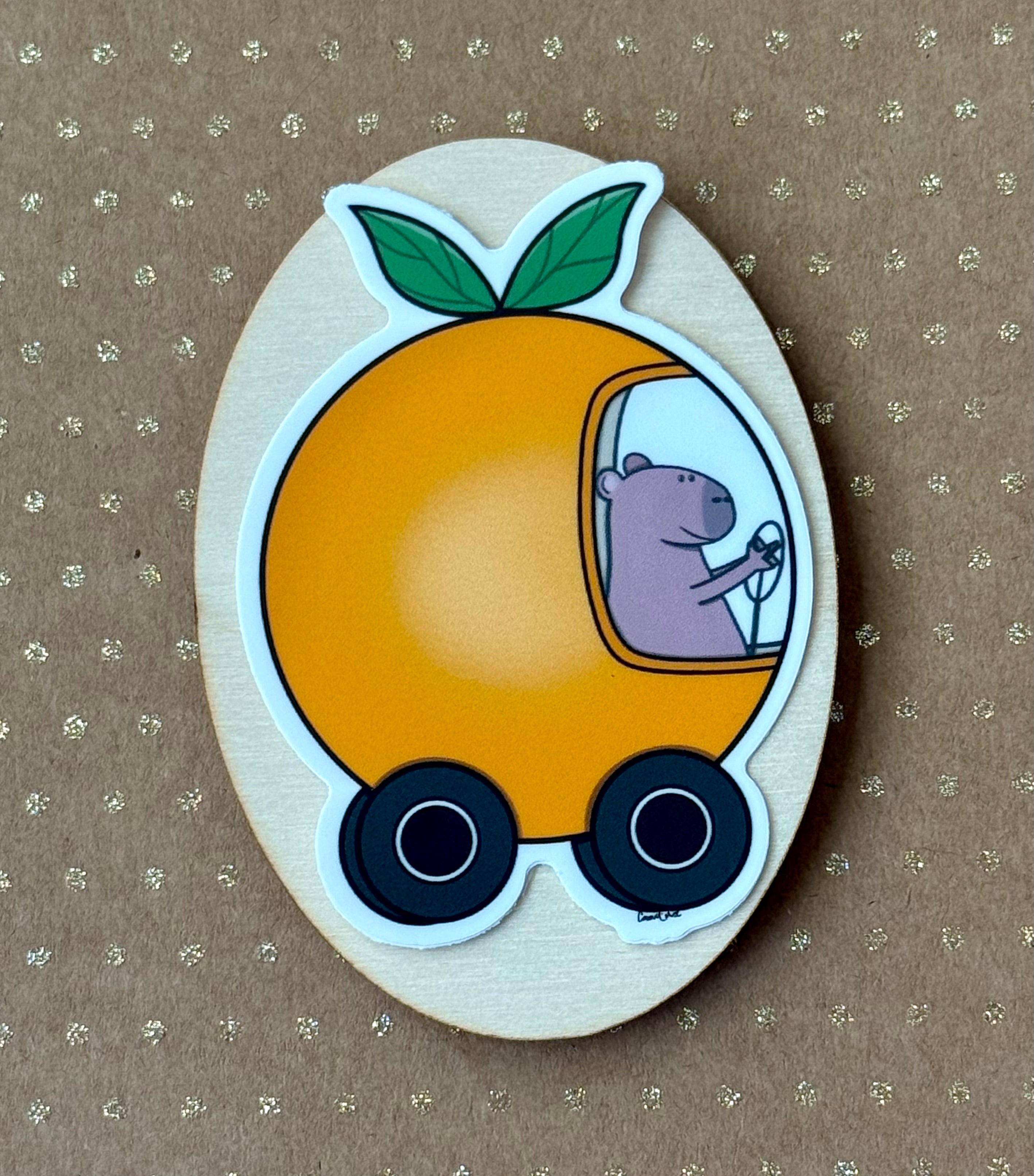 Capybara driving an orange car sticker