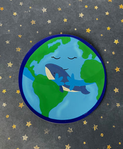 mother earth reusable vinyl sticker- mother earth is illustrated hugging our blue whale friend